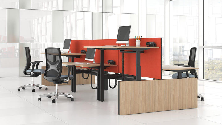 modern height adjsutable bench desks with red modesty panels
