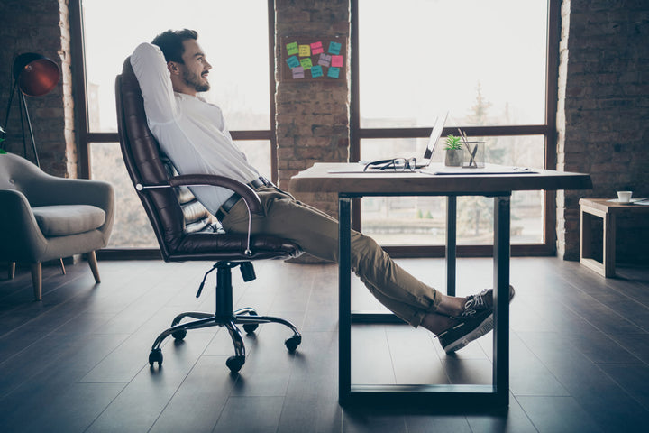 man on an office chair by an office desk