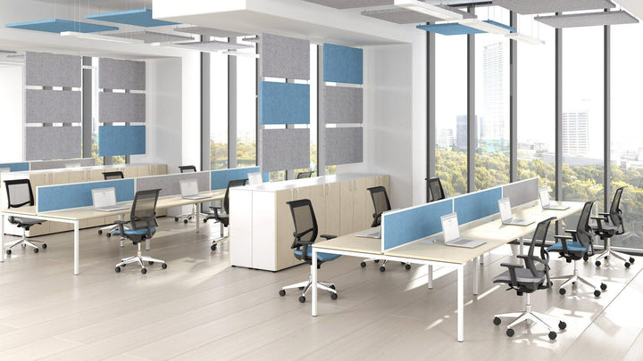 modern London office furnished with white bench desks, mesh operator chairs and fabric desk screens
