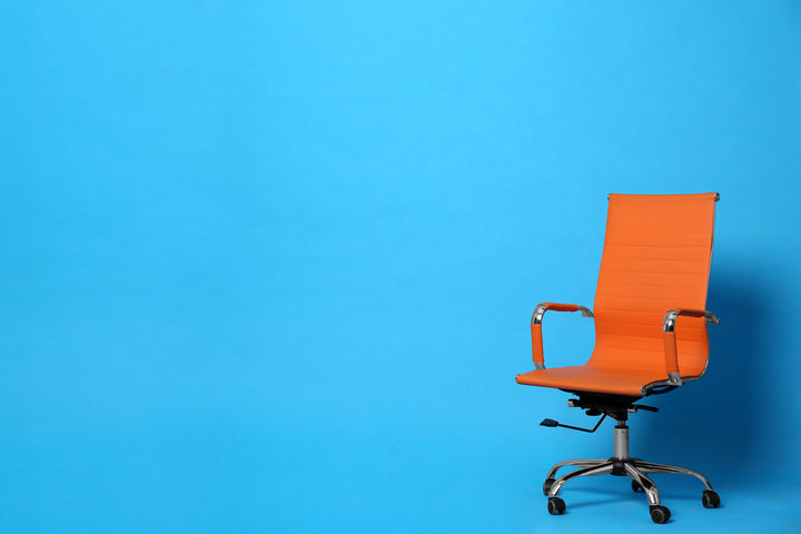 orange office chair on blue background